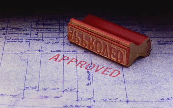Photo of blueprint with approved stamp